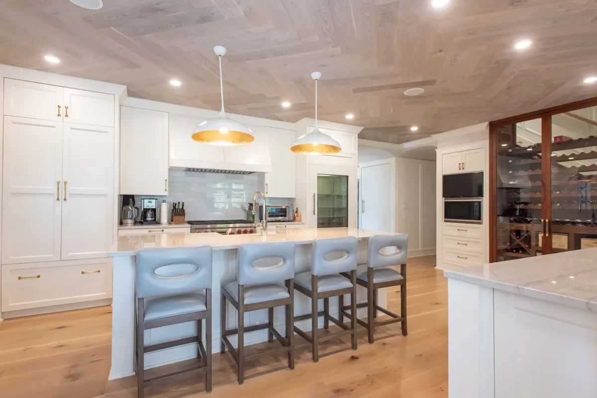 Kitchen with a central island, counter seating and brass pendants