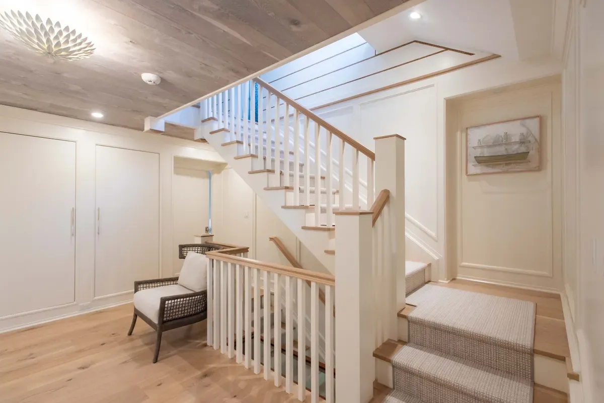 Second-floor landing and staircase with custom built-ins