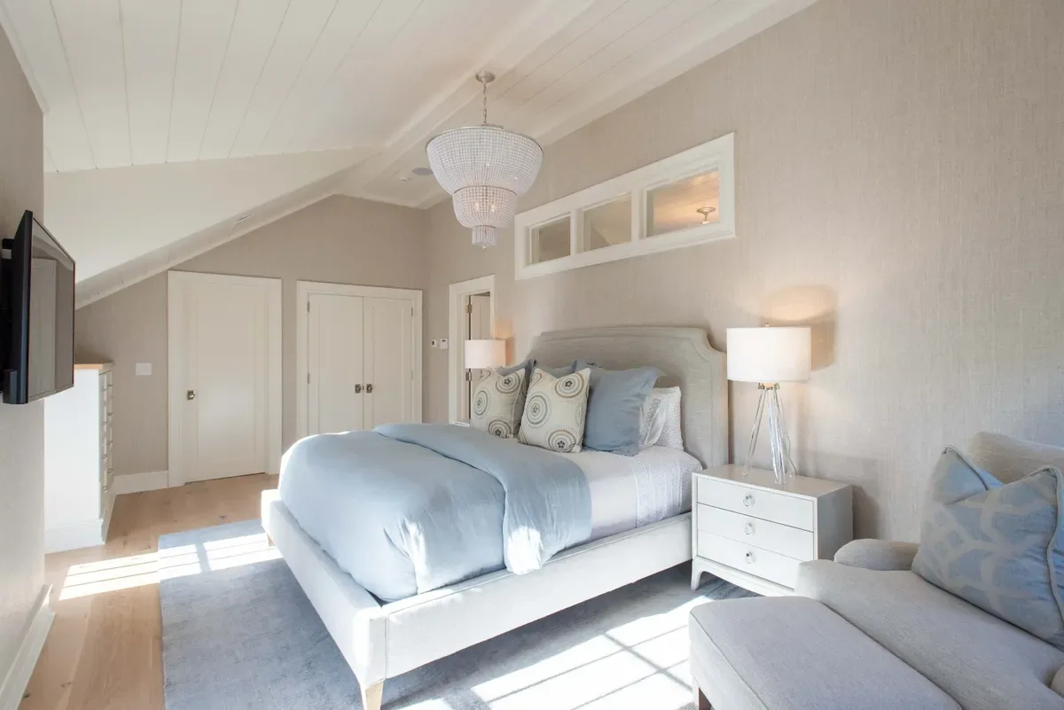 Master suite with a vaulted ceiling and the transom light above the bath door