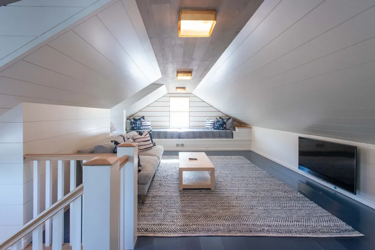 Third-floor playroom with shiplap to the ceiling and built-in full-size twin daybeds