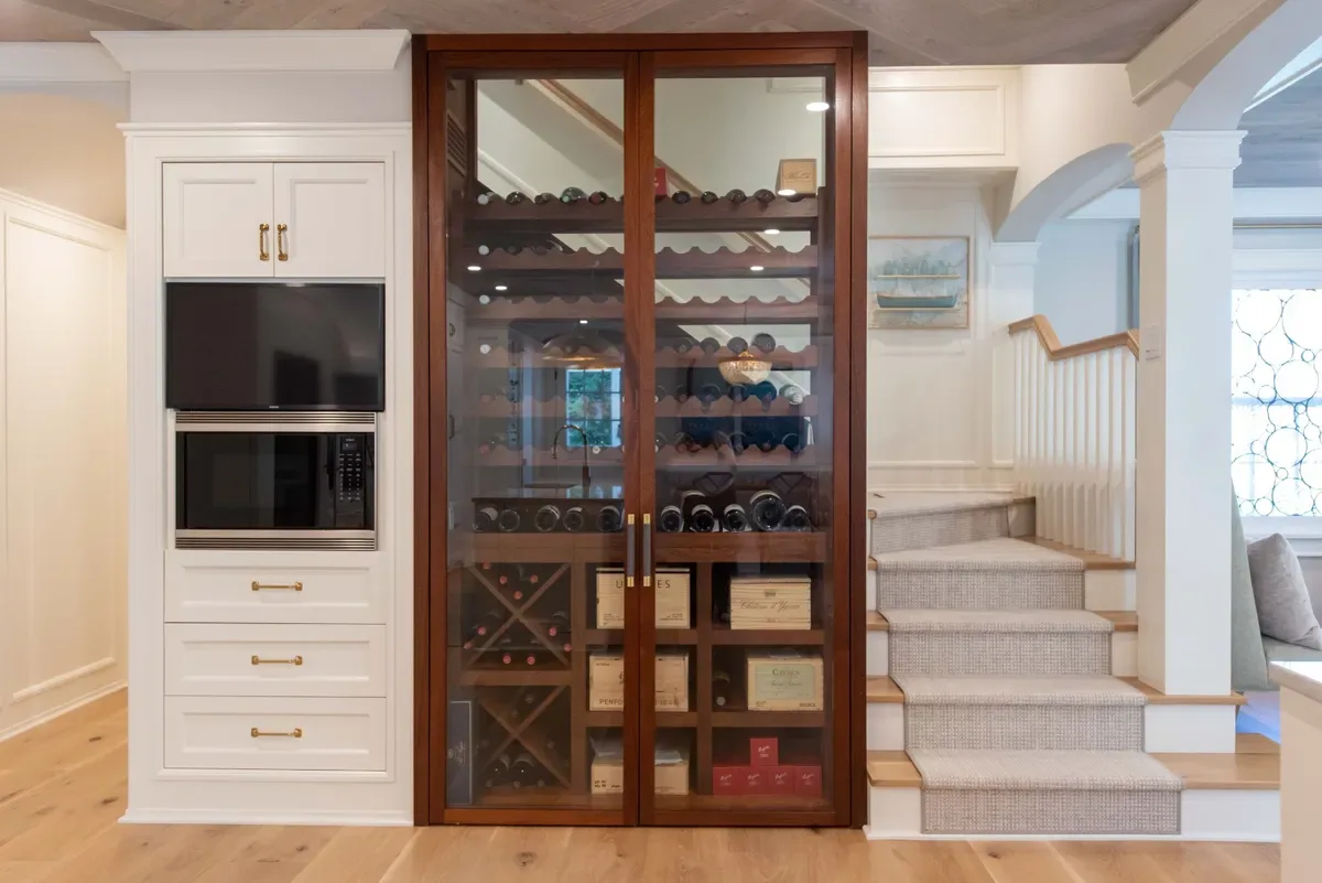 Mahogany and glass wine cellar with oversized glass doors